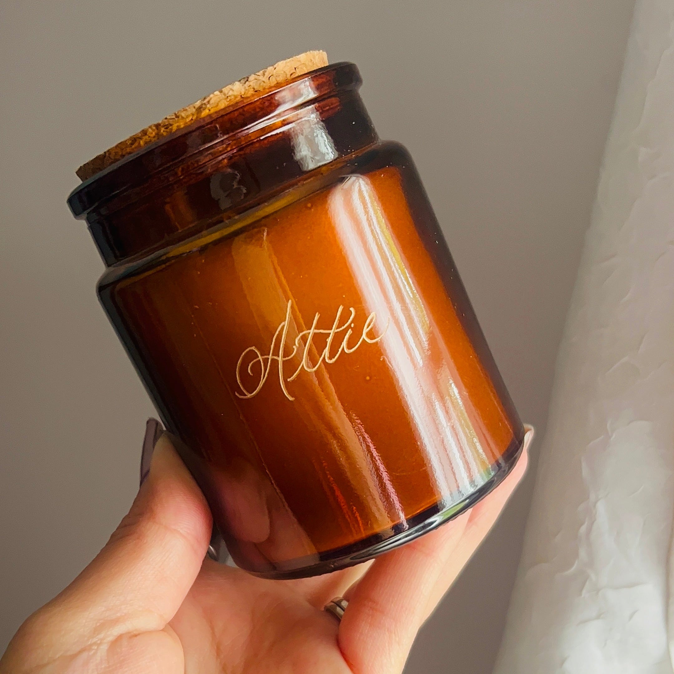 Hand holding glass engraving in prep for NYC engraving event