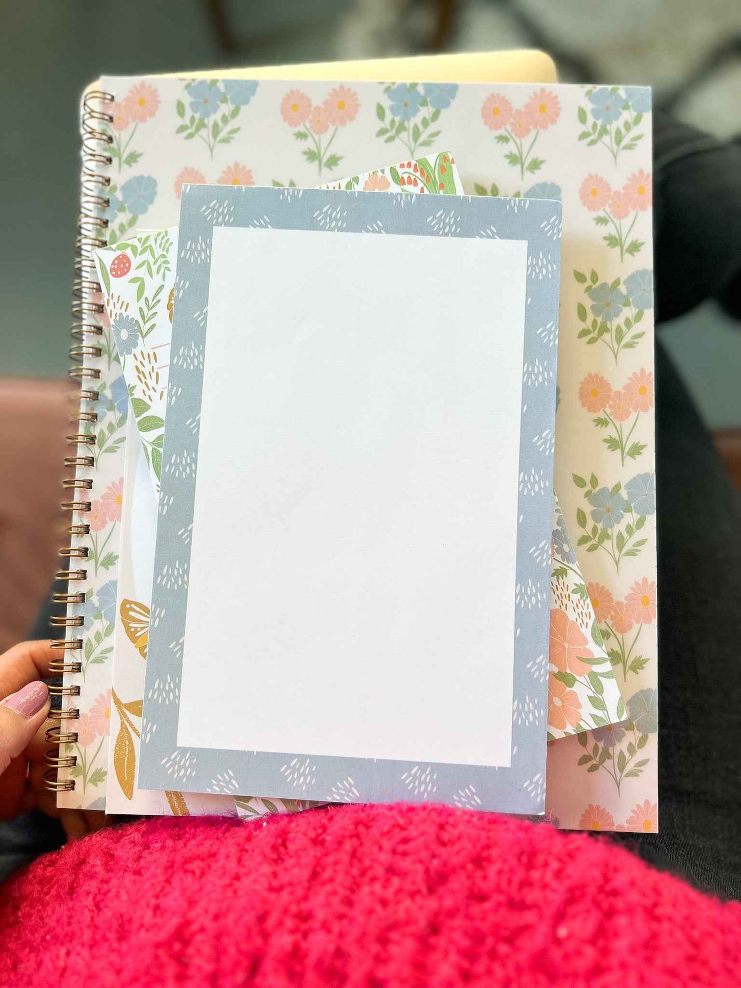 Pretty blue memo notepad on floral notebook