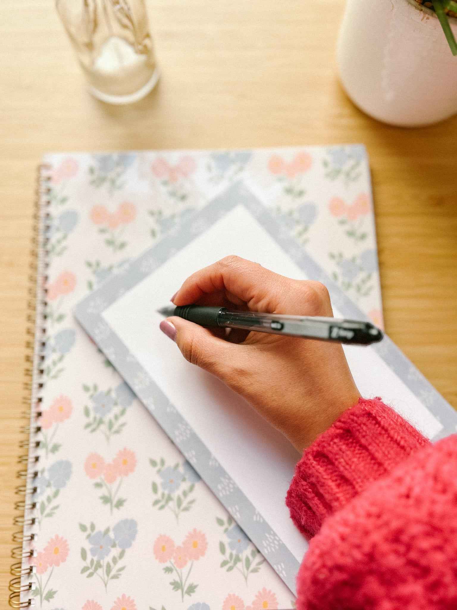 Hand on blue memo notepad 